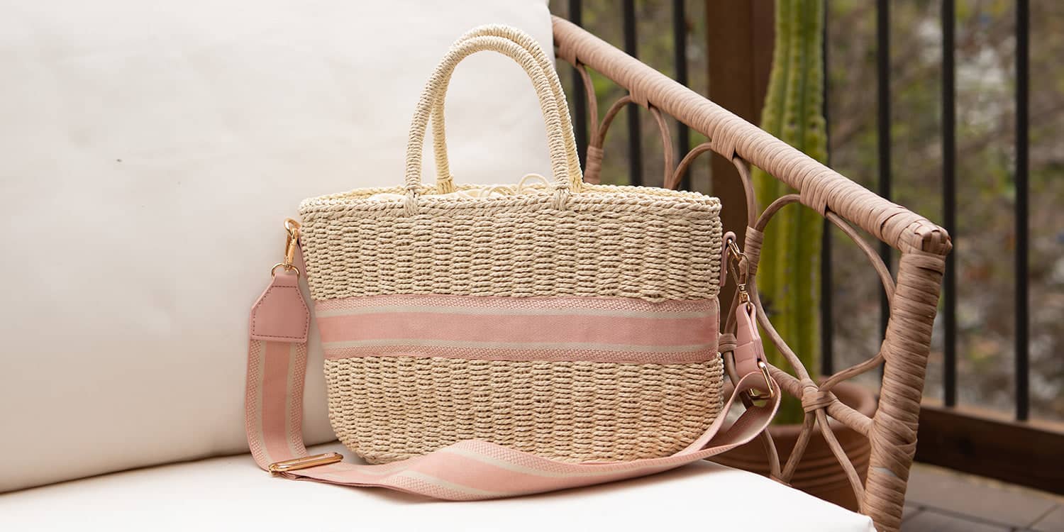 a straw beach bag sitting on patio furniture