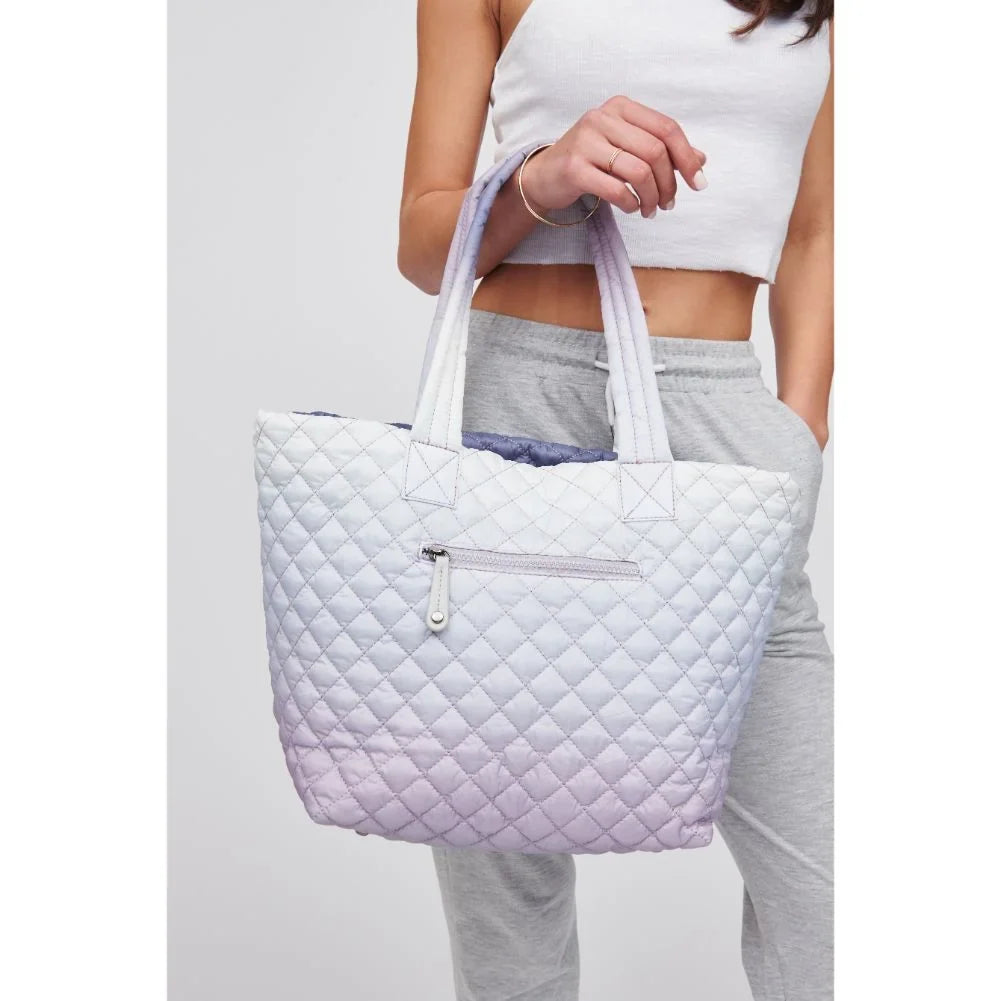 woman carrying a light purple tote bag