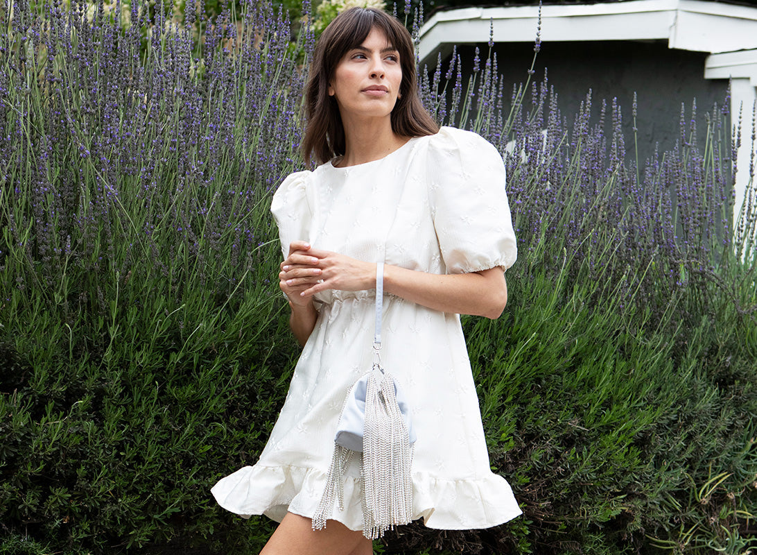 A woman holding a wedding guest purse