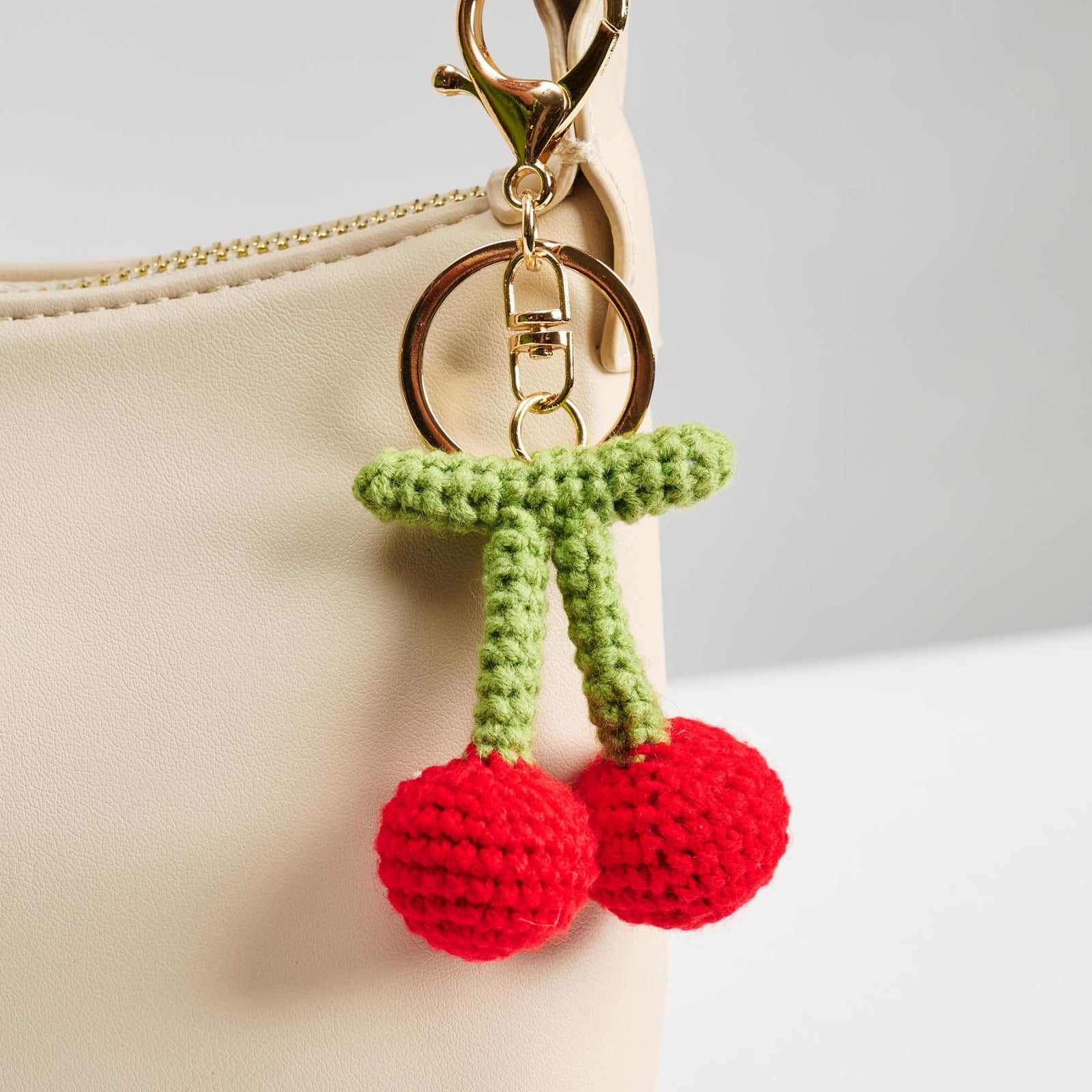Woman wearing Cherry Urban Expressions Grenadine Keychain Charm 840611150608 View 1 | Cherry