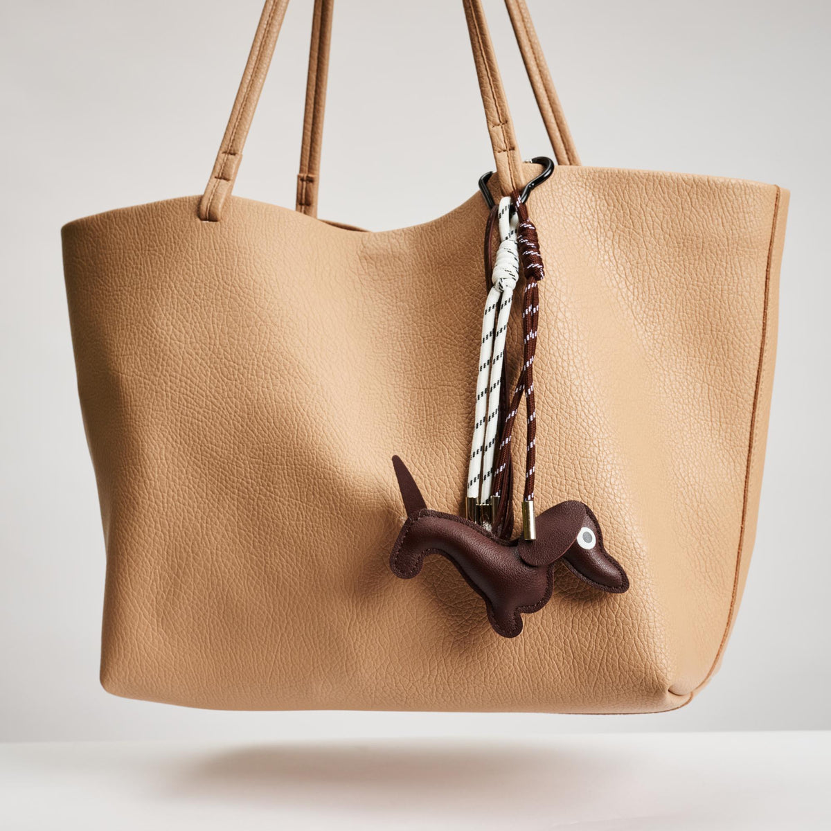 Woman wearing Brown Urban Expressions Hershey Hanging Charm 840611150660 View 2 | Brown