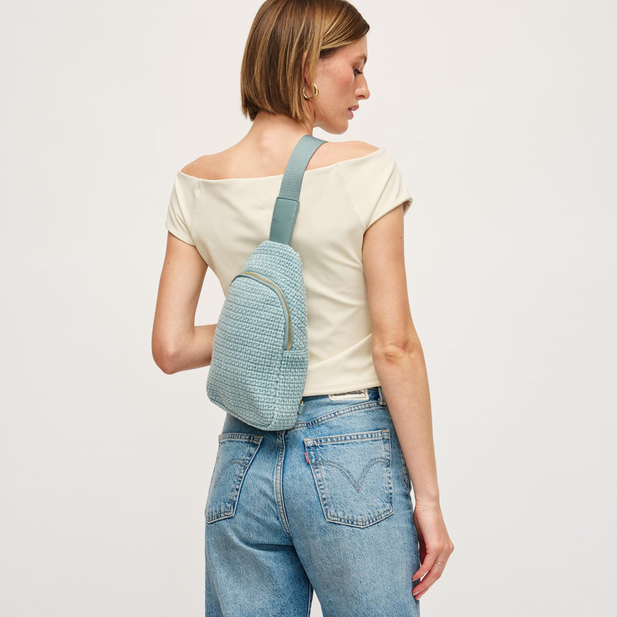 Woman wearing Blue Urban Expressions Jean Sling Backpack 840611146540 View 3 | Blue