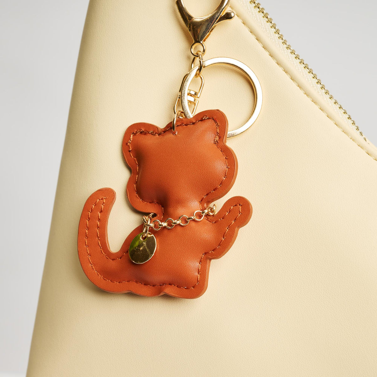 Woman wearing Tan Urban Expressions Kittie Keychain Charm 840611150745 View 1 | Tan