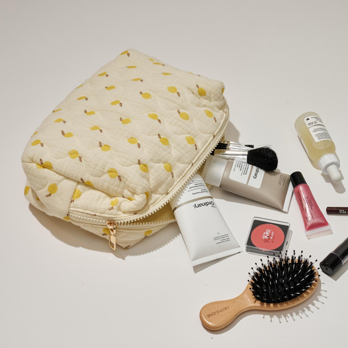 Woman wearing Lemon Urban Essentials Quilted Keeper Cosmetic & Travel Organizer Pouch 840611195432 View 2 | Lemon