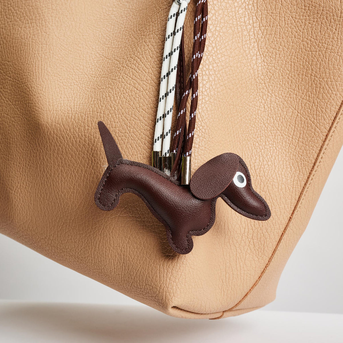 Woman wearing Brown Urban Expressions Hershey Hanging Charm 840611150660 View 1 | Brown