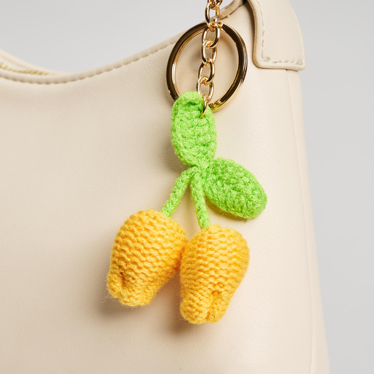 Woman wearing Lemon Urban Expressions Limoncello Keychain Charm 840611150592 View 1 | Lemon