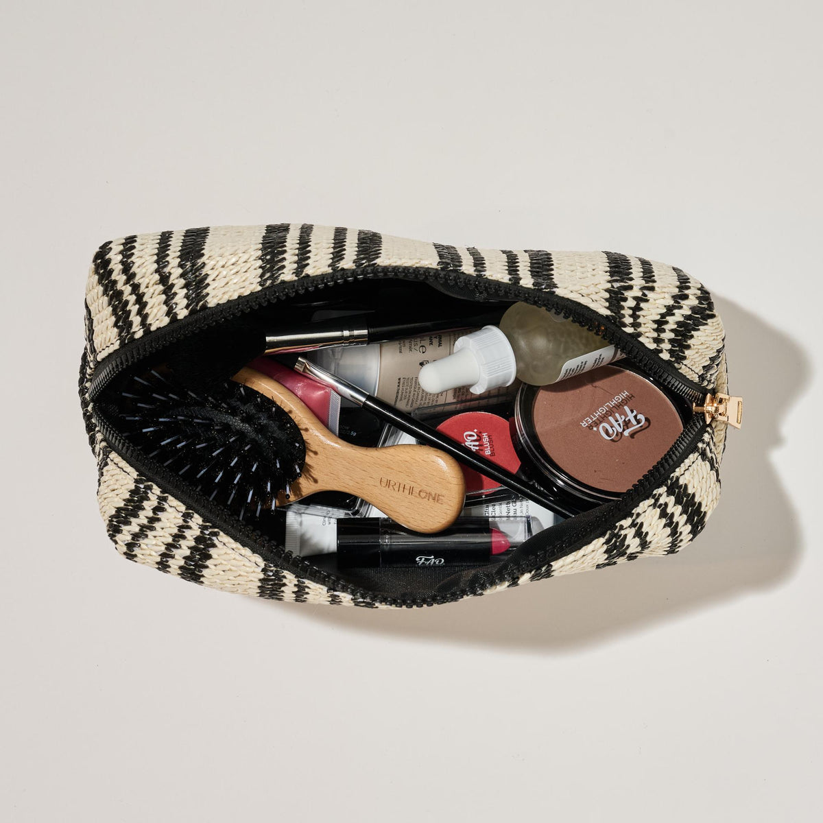 Woman wearing Black White Urban Essentials Voyage Stripe Cosmetic & Travel Organizer Pouch 840611152626 View 2 | Black White