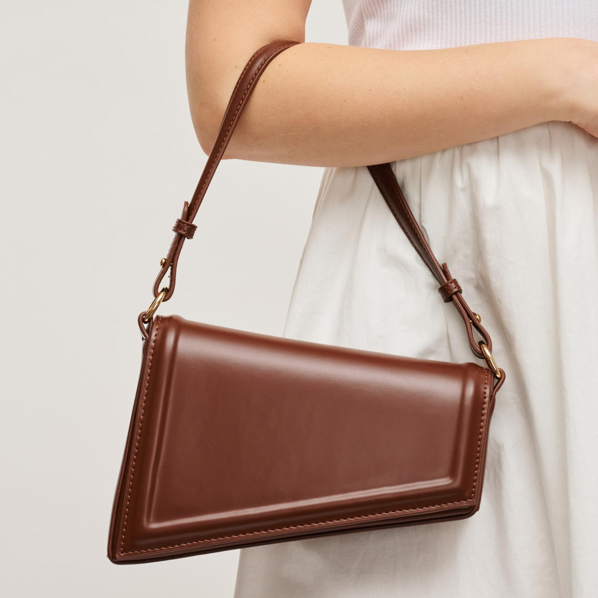 Woman wearing Chocolate Urban Expressions Sleek Contour Crossbody 840504200229 View 1 | Chocolate