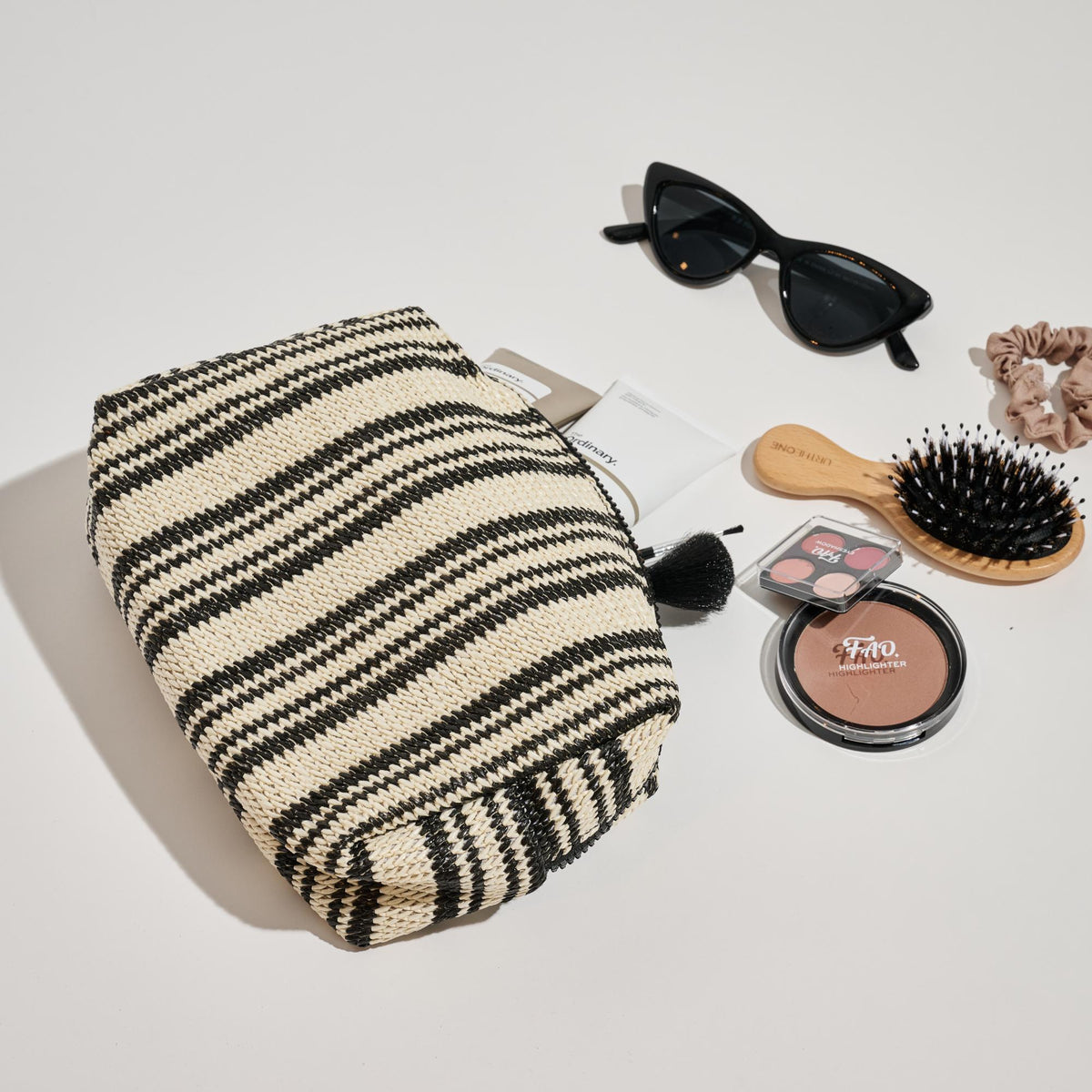 Woman wearing Black White Urban Essentials Voyage Stripe Cosmetic & Travel Organizer Pouch 840611152626 View 1 | Black White