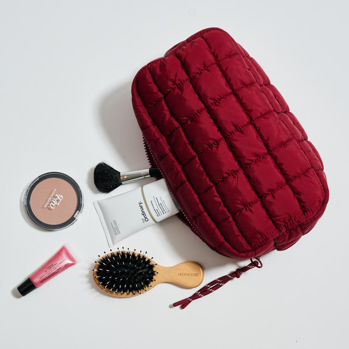 Woman wearing Burgundy Urban Essentials Cloud Nine - Puffer Cosmetic & Travel Organizer Pouch 840611197719 View 1 | Burgundy
