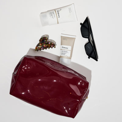 Woman wearing Red Urban Essentials Patent Pending Cosmetic & Travel Organizer Pouch 840611197313 View 1 | Red