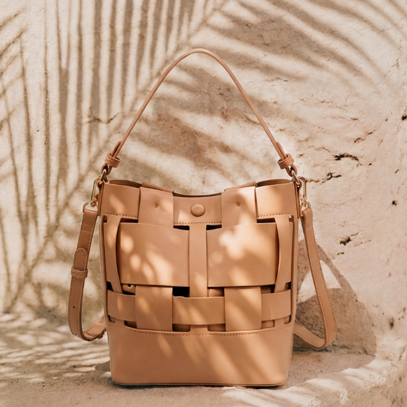 Beige woven handbag on a textured beige background